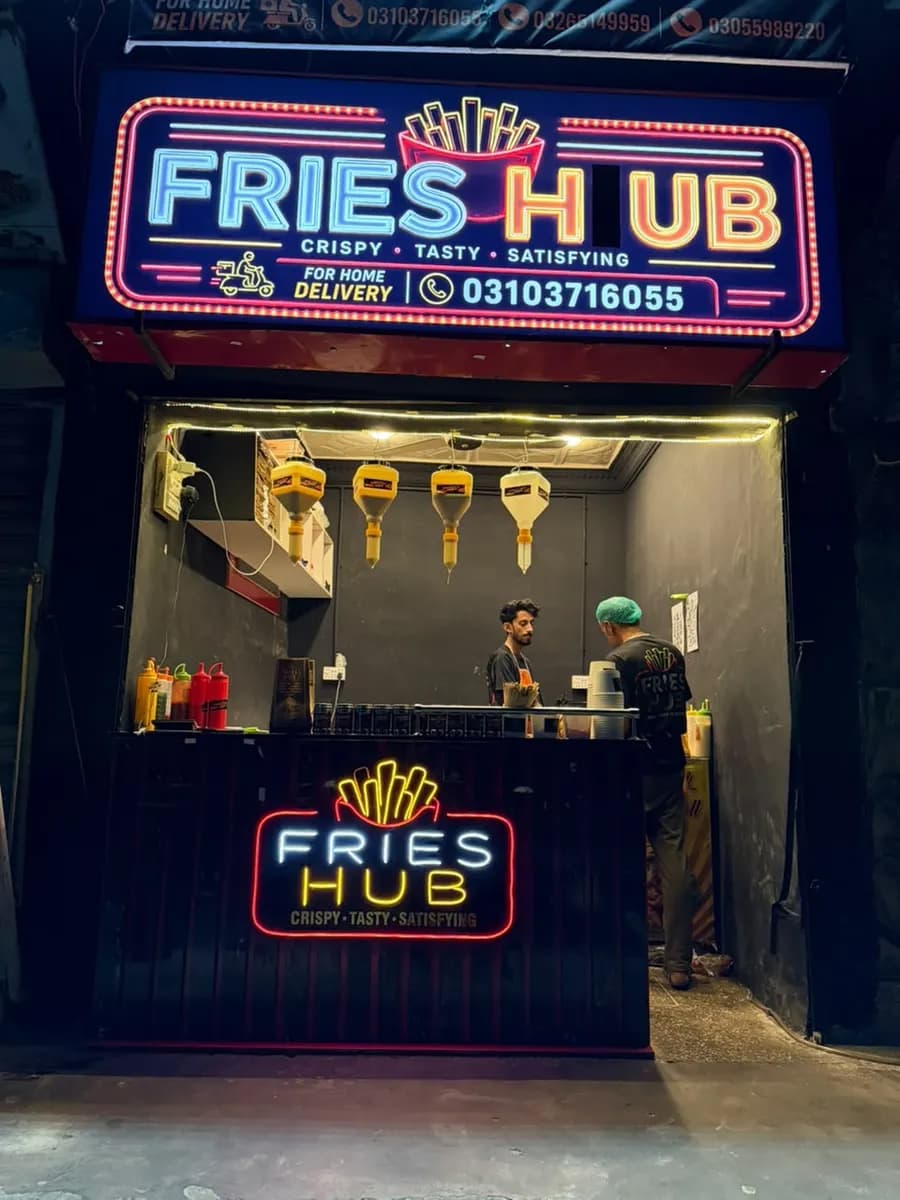 The Fries Hub counter with its neon logo